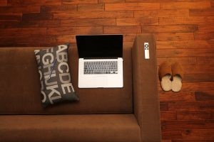 You can protect floors by using cardboard or newspapers. Just make sure that they don't move around Laptop on settee image